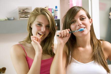 26260552-girls-brushing-teeth-in-the-bathroom